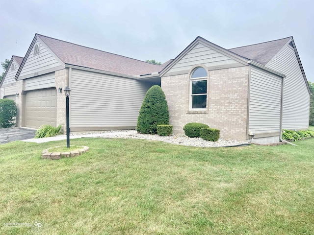 9330 Pinecrest Ct, Davison, MI 48423 - view of front facade with brick siding, an attached garage, a front lawn, driveway, and roof with shingles