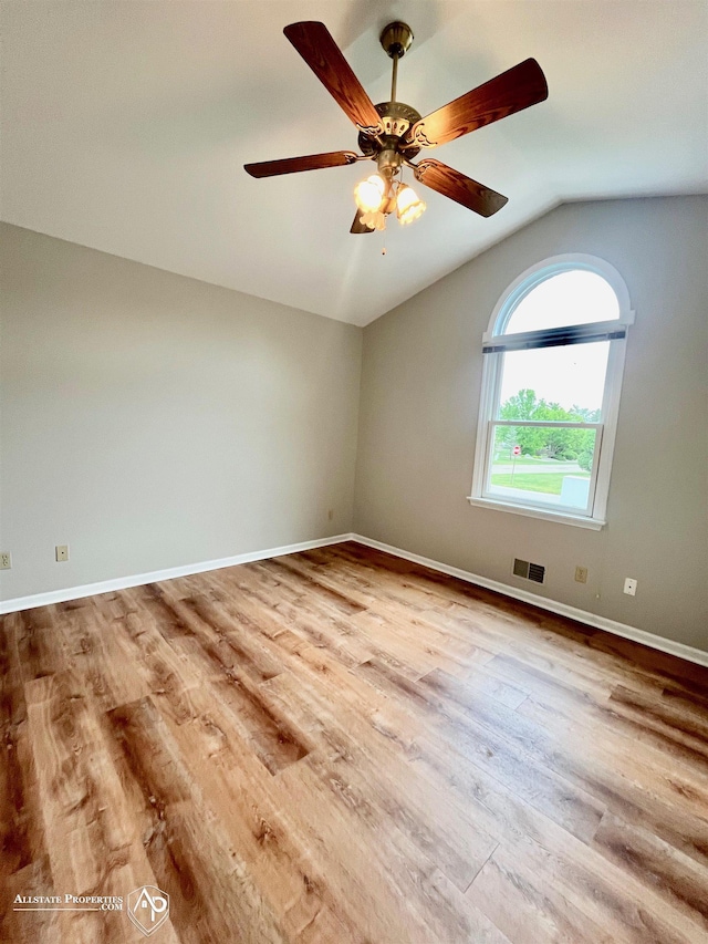 9330 Pinecrest Ct, Davison, MI 48423 - empty room featuring vaulted ceiling, wood finished floors, and a ceiling fan