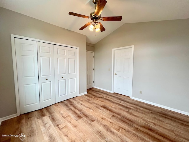 9330 Pinecrest Ct, Davison, MI 48423 - unfurnished bedroom with light wood-style floors, a closet, lofted ceiling, and ceiling fan