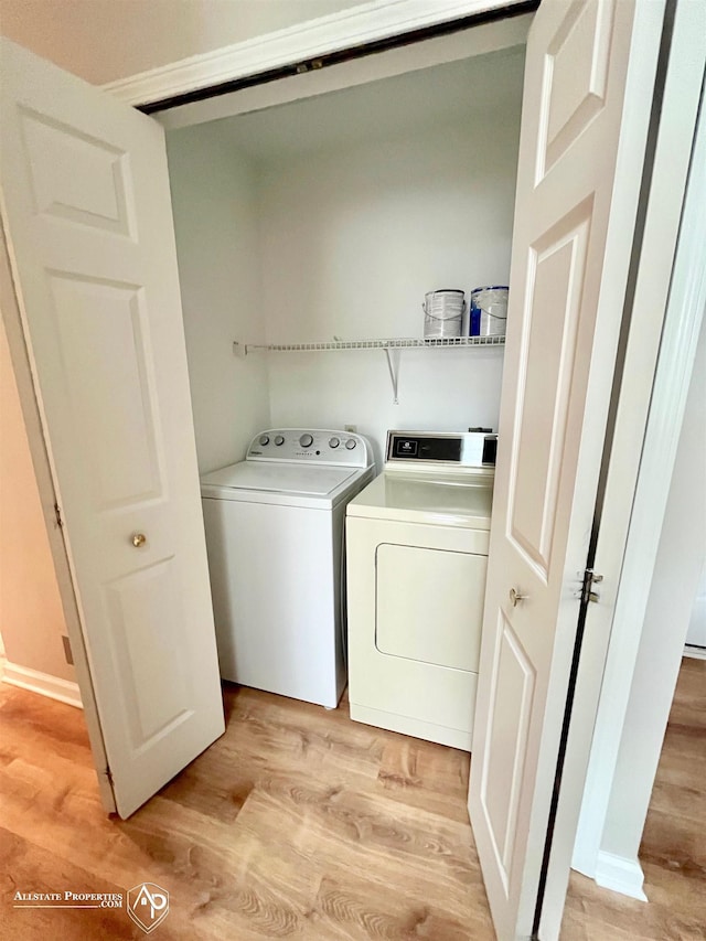 9330 Pinecrest Ct, Davison, MI 48423 - laundry room featuring separate washer and dryer and light wood-type flooring