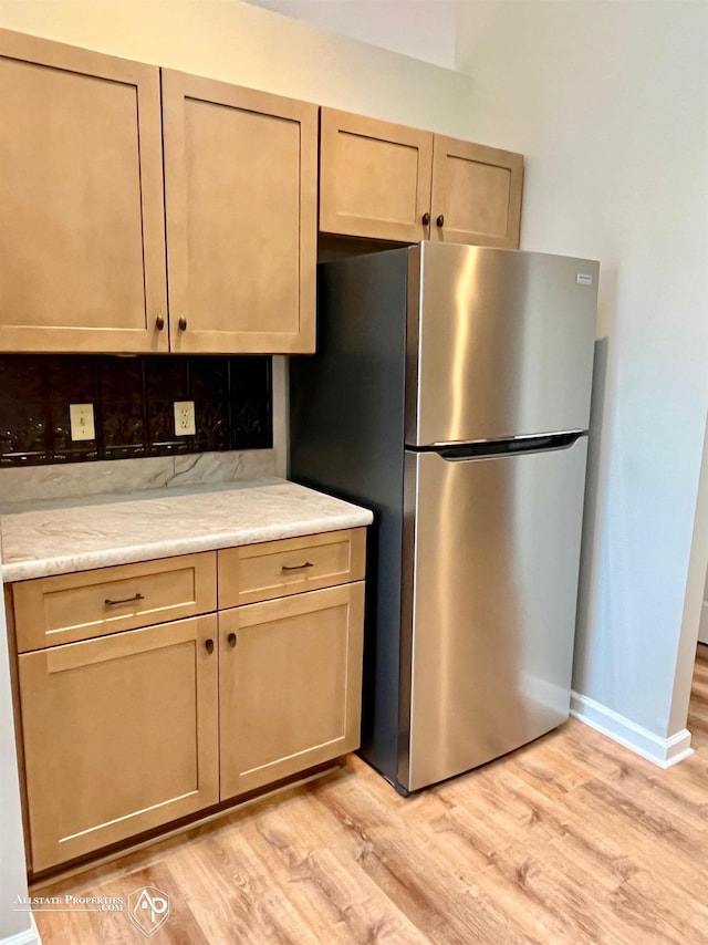 9330 Pinecrest Ct, Davison, MI 48423 - kitchen with freestanding refrigerator, light wood-style floors, and tasteful backsplash