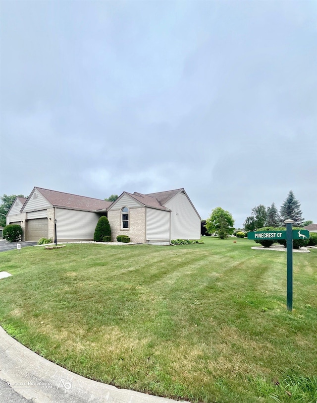 9330 Pinecrest Ct, Davison, MI 48423 - view of front of house with a garage, a front lawn, and brick siding