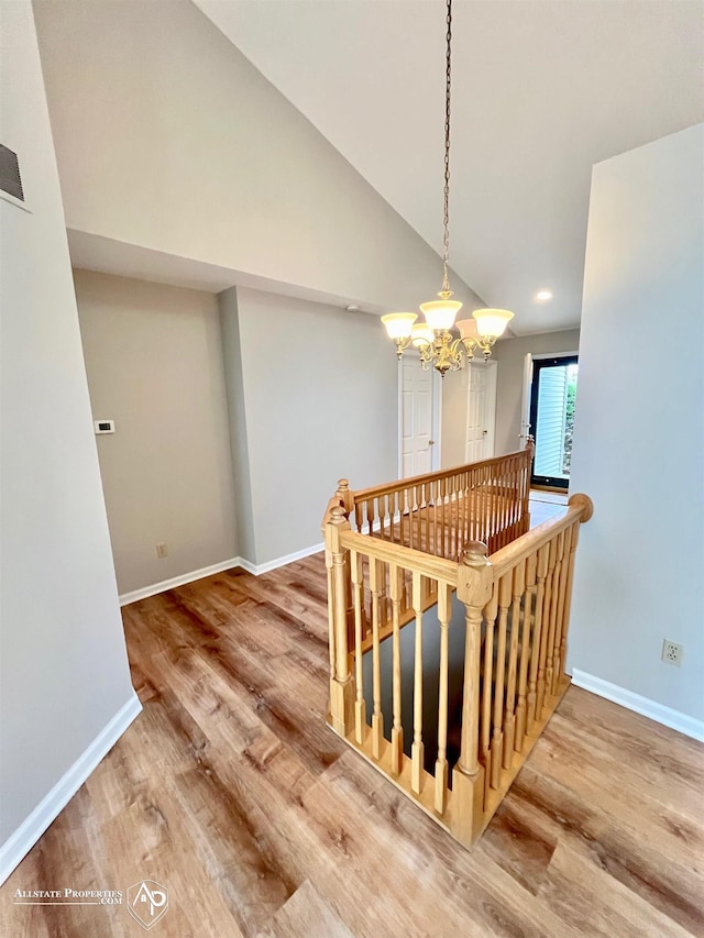 9330 Pinecrest Ct, Davison, MI 48423 - staircase featuring wood finished floors, a chandelier, lofted ceiling, and recessed lighting