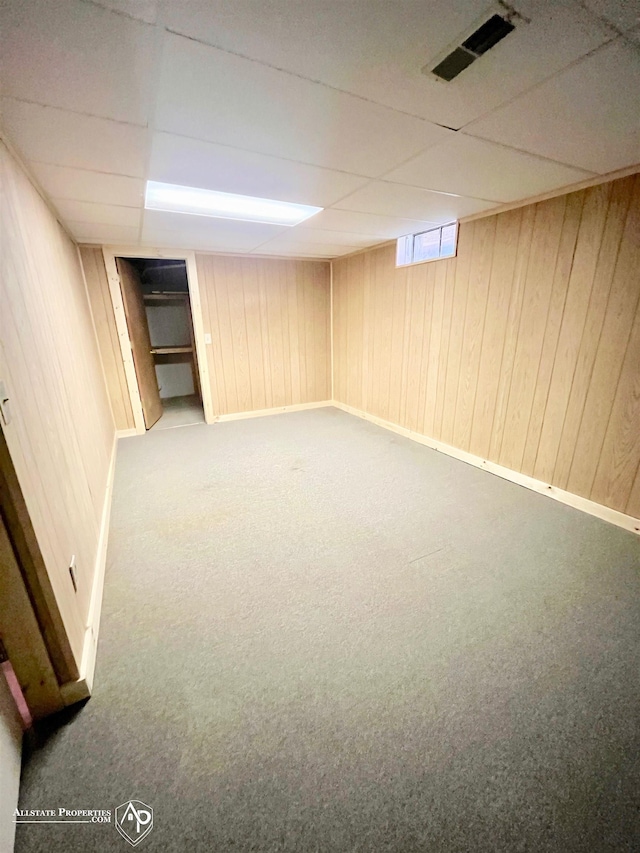 9330 Pinecrest Ct, Davison, MI 48423 - below grade area featuring carpet floors, a paneled ceiling, and wooden walls