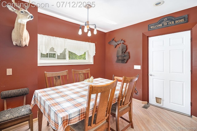 4420 Pinedale Ave, Clarkston, MI 48346 - dining room with a chandelier and light wood-style floors