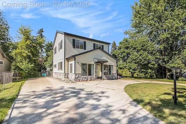4420 Pinedale Ave, Clarkston, MI 48346 - view of front of home with stone siding and concrete driveway