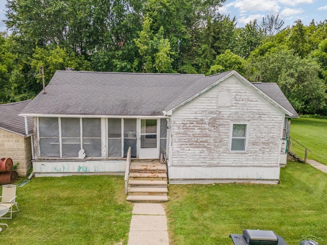 120 S Miami St, Saint Charles, MI 48655 - view of front of property featuring a sunroom, a front lawn, and roof with shingles