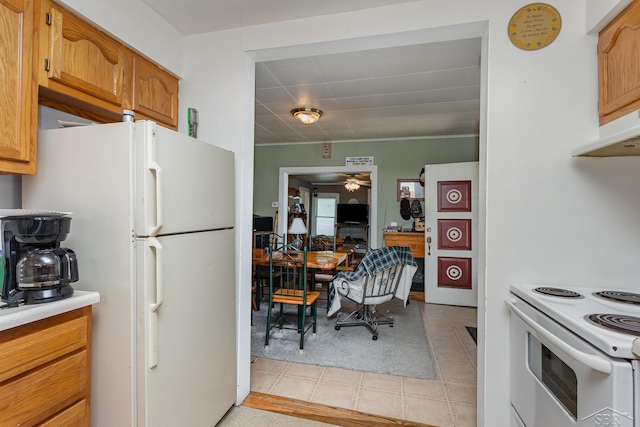120 S Miami St, Saint Charles, MI 48655 - kitchen featuring white appliances, a ceiling fan, light countertops, brown cabinets, and light tile patterned flooring