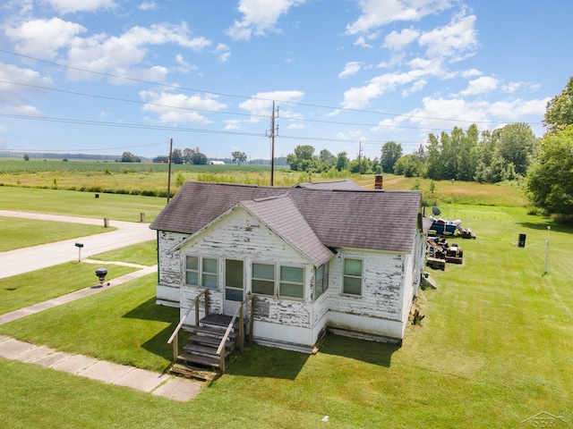 120 S Miami St, Saint Charles, MI 48655 - view of front of house with a shingled roof, stone siding, and a front lawn