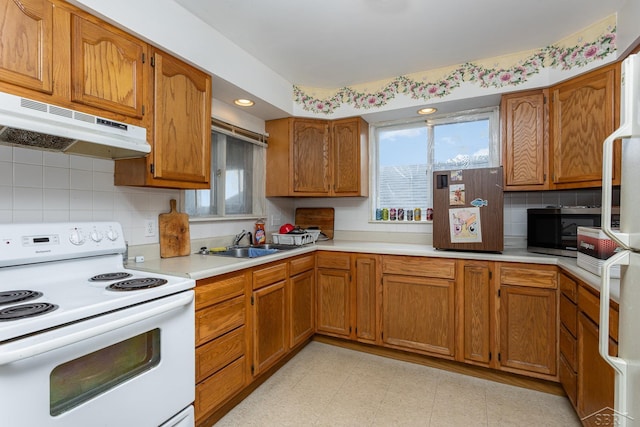 120 S Miami St, Saint Charles, MI 48655 - kitchen with white electric range oven, under cabinet range hood, stainless steel microwave, healthy amount of natural light, and recessed lighting