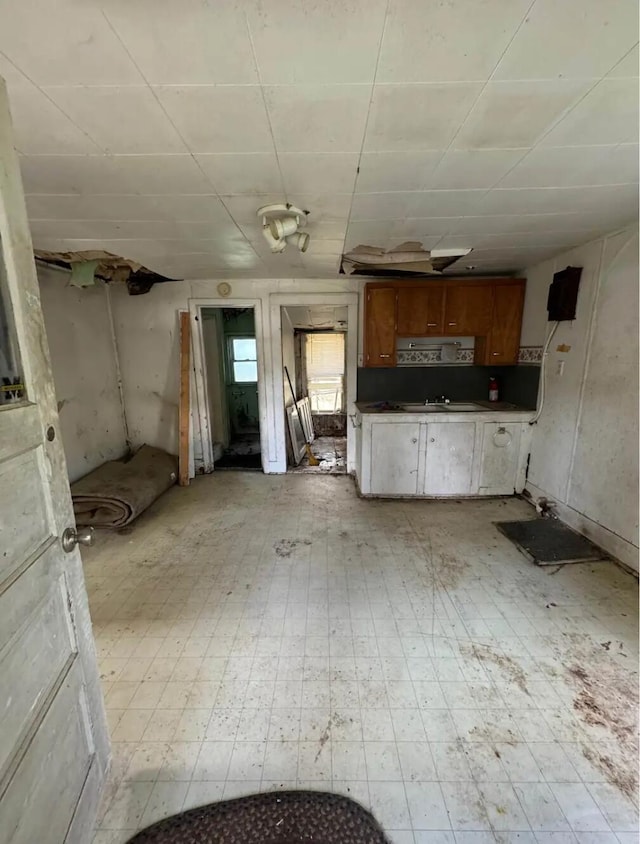 6596 Hillsinger St, Elwell, MI 48832 - kitchen featuring brown cabinetry and dark countertops