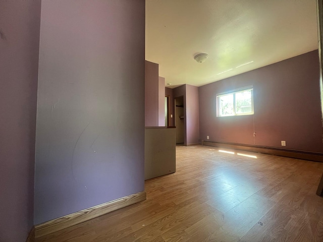 129 W Walnut St, Saint Charles, MI 48655 - unfurnished room with a baseboard heating unit and light wood-style flooring