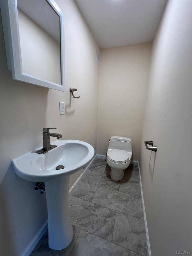 1999 Harold St, Adrian, MI 49221 - half bathroom with marble finish floors and baseboards