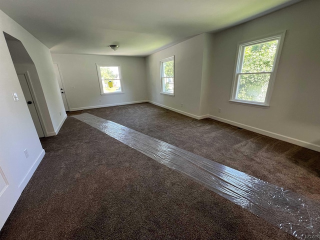 1999 Harold St, Adrian, MI 49221 - spare room with dark colored carpet and baseboards