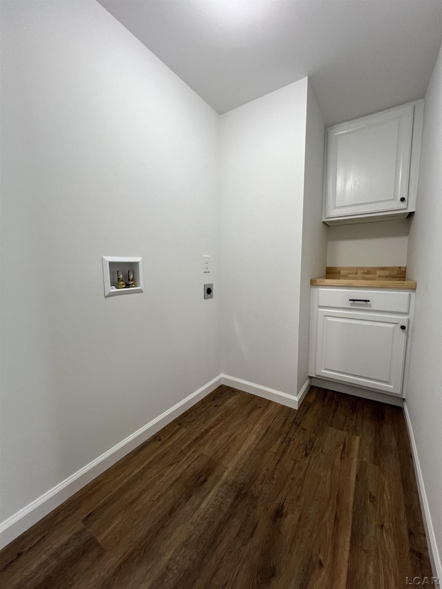 1999 Harold St, Adrian, MI 49221 - laundry area with electric dryer hookup, washer hookup, dark wood finished floors, and cabinet space