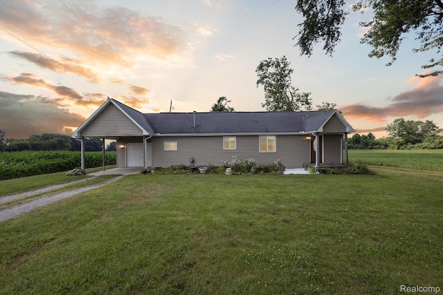 1612 Fischer Dr, Saginaw, MI 48601 - ranch-style house with driveway, a garage, and a lawn