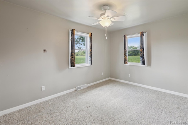 1612 Fischer Dr, Saginaw, MI 48601 - empty room featuring plenty of natural light, ceiling fan, and carpet floors