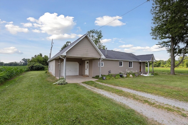 1612 Fischer Dr, Saginaw, MI 48601 - view of front facade with driveway, an attached garage, and a front lawn