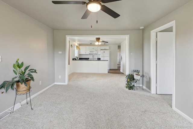 1612 Fischer Dr, Saginaw, MI 48601 - unfurnished living room with a ceiling fan and carpet