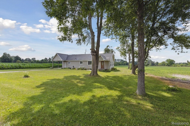 1612 Fischer Dr, Saginaw, MI 48601 - view of green lawn featuring a view of countryside and a carport