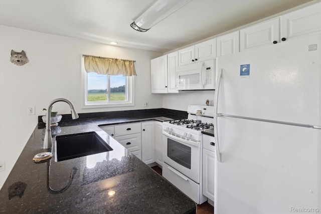 1612 Fischer Dr, Saginaw, MI 48601 - kitchen with white appliances, white cabinetry, and dark stone countertops
