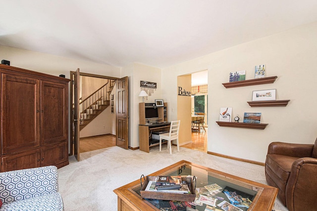 1410 Rothbury Dr NE, Grand Rapids, MI 49505 - living room featuring light colored carpet and stairway