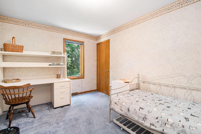 1410 Rothbury Dr NE, Grand Rapids, MI 49505 - bedroom with light carpet, built in desk, and wallpapered walls
