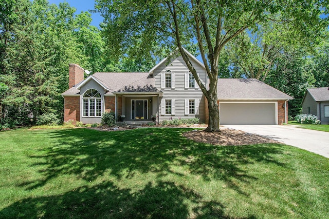1410 Rothbury Dr NE, Grand Rapids, MI 49505 - traditional home featuring concrete driveway, a chimney, an attached garage, a front yard, and brick siding