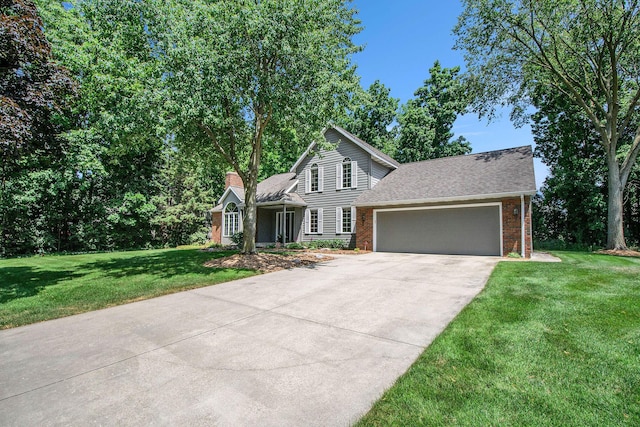 1410 Rothbury Dr NE, Grand Rapids, MI 49505 - traditional-style home with an attached garage, a front yard, driveway, a chimney, and brick siding