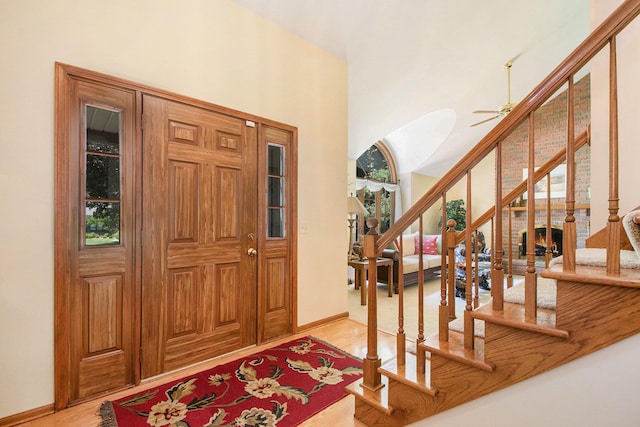 1410 Rothbury Dr NE, Grand Rapids, MI 49505 - foyer featuring light wood finished floors, stairway, a ceiling fan, and a towering ceiling