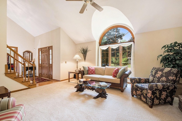 1410 Rothbury Dr NE, Grand Rapids, MI 49505 - carpeted living room featuring stairway, ceiling fan, and high vaulted ceiling