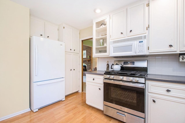 1410 Rothbury Dr NE, Grand Rapids, MI 49505 - kitchen featuring white appliances, dark countertops, light wood-type flooring, decorative backsplash, and recessed lighting