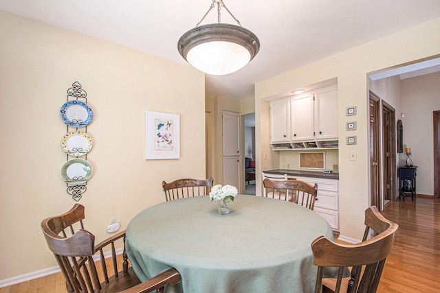 1410 Rothbury Dr NE, Grand Rapids, MI 49505 - dining room featuring light wood-style flooring and baseboards