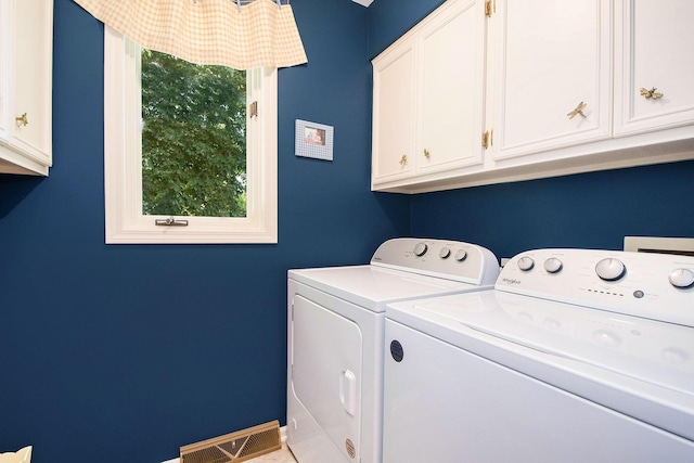 1410 Rothbury Dr NE, Grand Rapids, MI 49505 - laundry area featuring washer and clothes dryer and cabinet space
