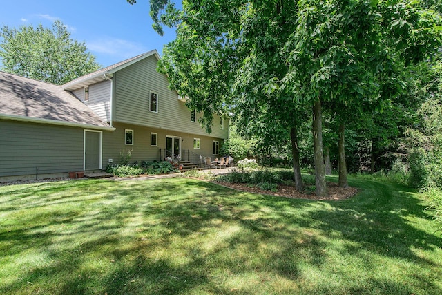 1410 Rothbury Dr NE, Grand Rapids, MI 49505 - view of grassy yard featuring a patio