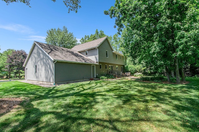 1410 Rothbury Dr NE, Grand Rapids, MI 49505 - view of side of home featuring a yard and roof with shingles