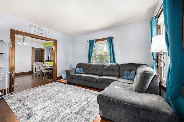 2028 Rowe Ave NE, Grand Rapids, MI 49505 - living room featuring a chandelier and wood finished floors