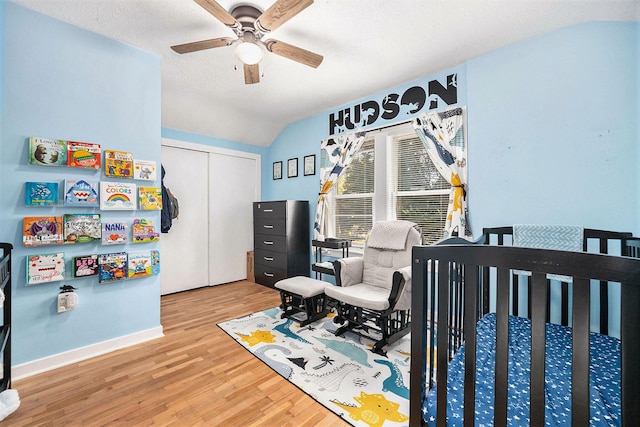 2028 Rowe Ave NE, Grand Rapids, MI 49505 - bedroom with vaulted ceiling, wood finished floors, a closet, a ceiling fan, and a textured ceiling