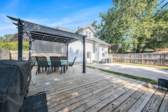 2028 Rowe Ave NE, Grand Rapids, MI 49505 - wooden terrace with outdoor dining area, a fenced backyard, a pergola, and area for grilling
