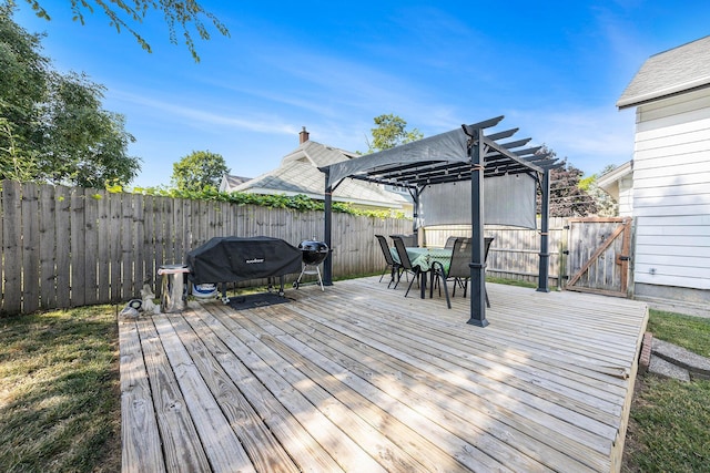 2028 Rowe Ave NE, Grand Rapids, MI 49505 - deck featuring grilling area, a pergola, a fenced backyard, a gate, and outdoor dining area