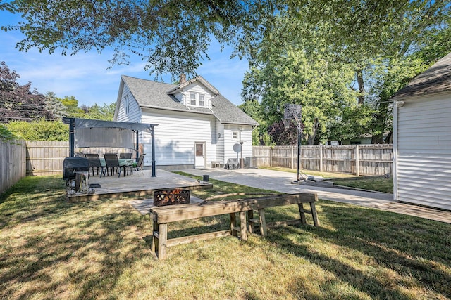 2028 Rowe Ave NE, Grand Rapids, MI 49505 - rear view of property featuring a deck, a fenced backyard, and a shingled roof