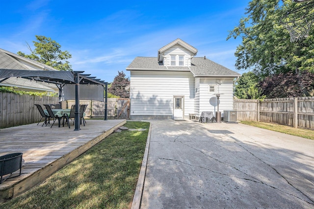 2028 Rowe Ave NE, Grand Rapids, MI 49505 - rear view of house featuring a deck, a fenced backyard, outdoor dining space, a shingled roof, and a pergola