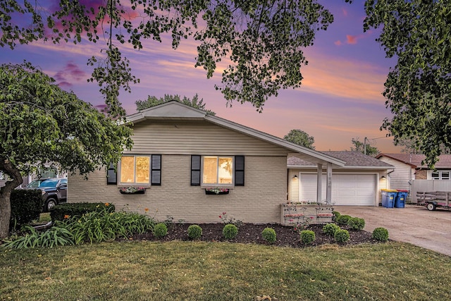 1836 Ridgewood Ave SE, Grand Rapids, MI 49506 - view of front facade featuring an attached garage, concrete driveway, a lawn, and brick siding