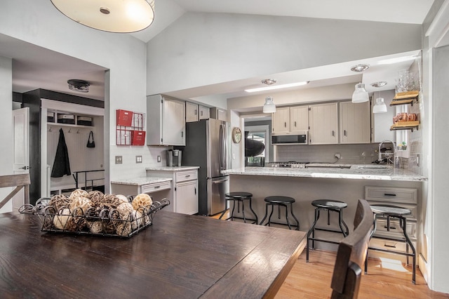 1836 Ridgewood Ave SE, Grand Rapids, MI 49506 - dining room with light wood-style flooring and high vaulted ceiling