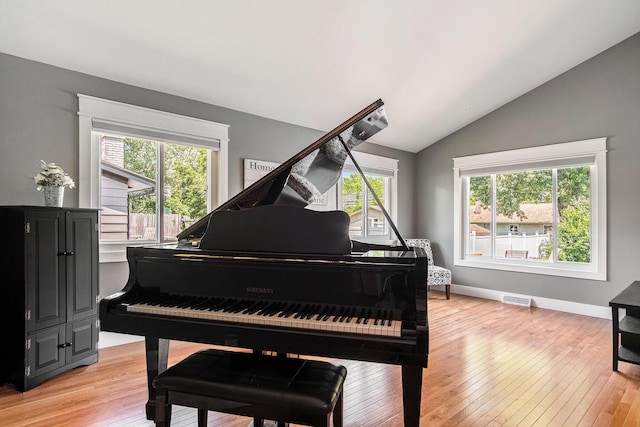 1836 Ridgewood Ave SE, Grand Rapids, MI 49506 - living area featuring vaulted ceiling and light wood-type flooring