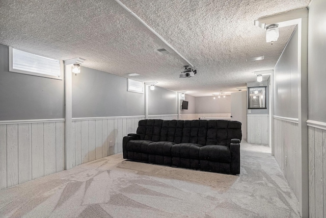 1836 Ridgewood Ave SE, Grand Rapids, MI 49506 - living room featuring a wainscoted wall, carpet, a textured ceiling, and wood walls