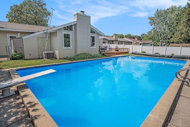 1836 Ridgewood Ave SE, Grand Rapids, MI 49506 - view of pool with a diving board, a wooden deck, and a storage unit