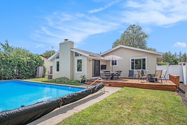 1836 Ridgewood Ave SE, Grand Rapids, MI 49506 - rear view of property with outdoor dining space, a wooden deck, and a chimney