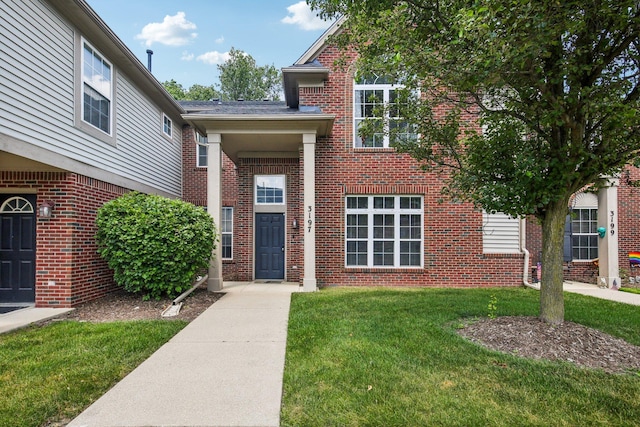3197 Primrose Ln, Ypsilanti, MI 48197 - view of front facade with brick siding and a front lawn