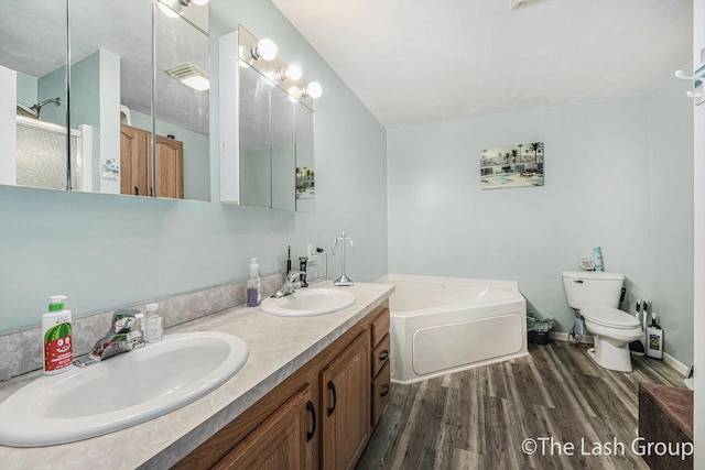 2851 18 Mile Rd, Kent City, MI 49330 - bathroom featuring wood finished floors, a garden tub, double vanity, and a shower with shower door